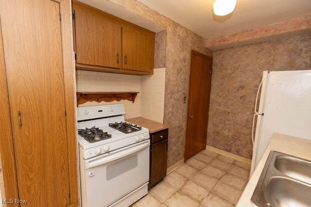 1114 W Miner Rd, Mayfield Heights, OH 44124 - kitchen with gas range gas stove, light countertops, and brown cabinetry