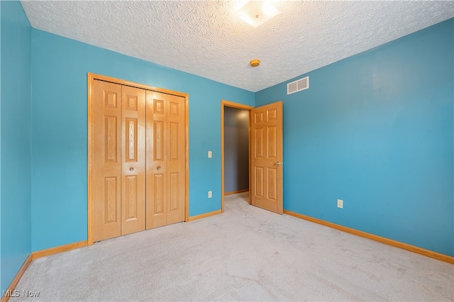 2919 Pepper Hill Cir, Akron, OH 44312 - unfurnished bedroom featuring a closet, carpet floors, and a textured ceiling