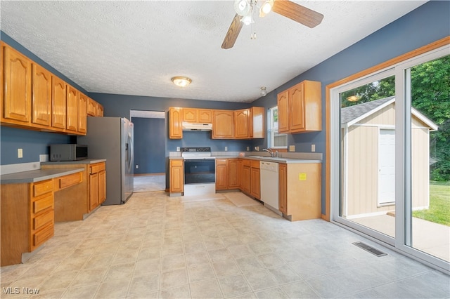 2919 Pepper Hill Cir, Akron, OH 44312 - kitchen with appliances with stainless steel finishes, a textured ceiling, under cabinet range hood, ceiling fan, and brown cabinetry