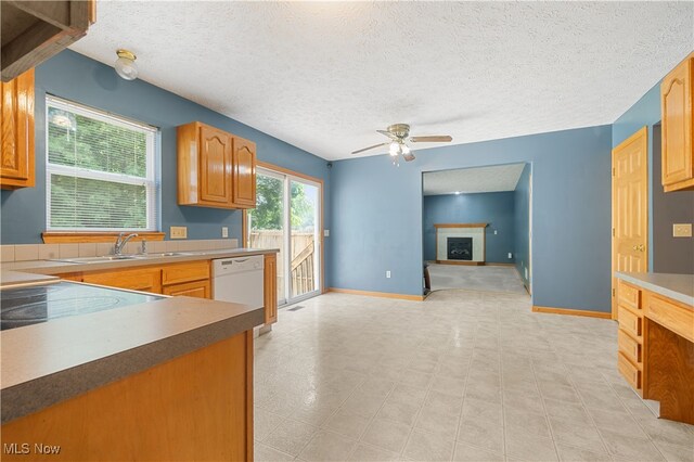 2919 Pepper Hill Cir, Akron, OH 44312 - kitchen with white dishwasher, ceiling fan, a textured ceiling, open floor plan, and stove