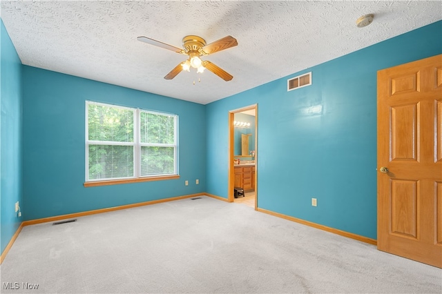 2919 Pepper Hill Cir, Akron, OH 44312 - unfurnished bedroom with carpet floors, a textured ceiling, a ceiling fan, and ensuite bath