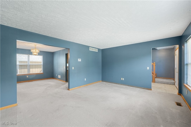 2919 Pepper Hill Cir, Akron, OH 44312 - carpeted empty room with a chandelier and a textured ceiling