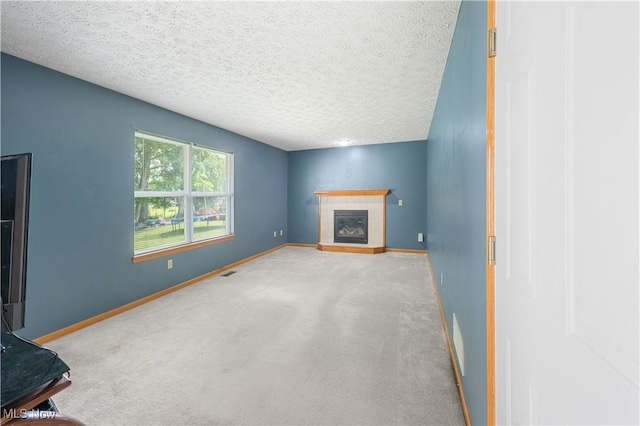 2919 Pepper Hill Cir, Akron, OH 44312 - unfurnished living room with carpet floors, a tile fireplace, and a textured ceiling