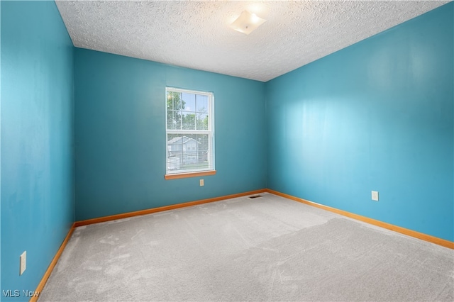2919 Pepper Hill Cir, Akron, OH 44312 - spare room featuring a textured ceiling and carpet flooring