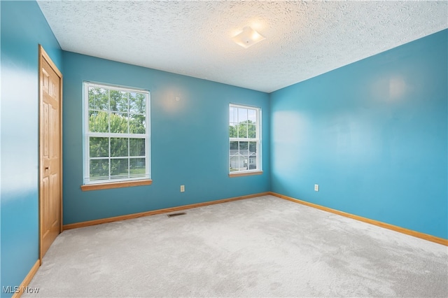 2919 Pepper Hill Cir, Akron, OH 44312 - carpeted spare room with healthy amount of natural light and a textured ceiling