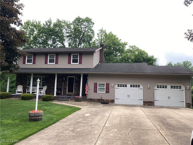 505 Garver, Youngstown, OH 44512 - view of front facade featuring a garage, driveway, a front yard, covered porch, and stone siding
