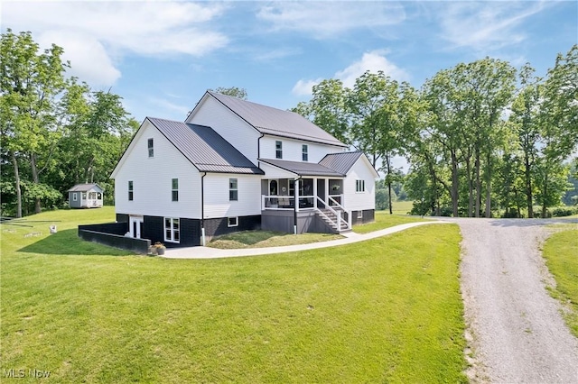 59301 Honeybee Rd, Senecaville, OH 43780 - back of house with a sunroom, a lawn, and a metal roof