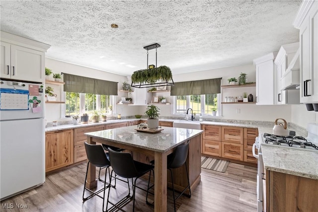 59301 Honeybee Rd, Senecaville, OH 43780 - kitchen with open shelves, freestanding refrigerator, gas stove, healthy amount of natural light, and a textured ceiling