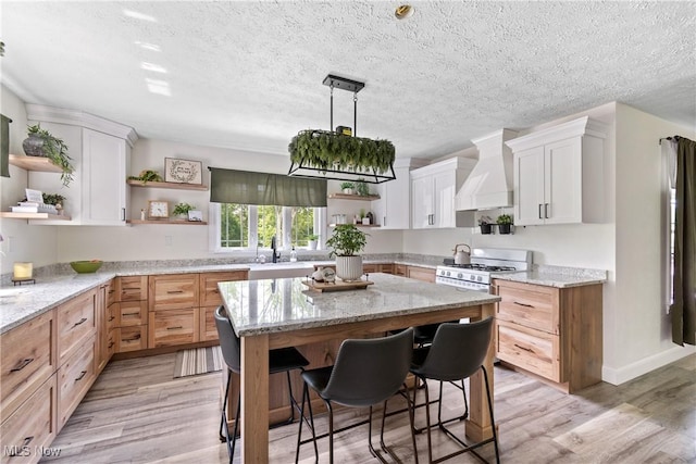 59301 Honeybee Rd, Senecaville, OH 43780 - kitchen with open shelves, custom range hood, a center island, a kitchen bar, and light stone countertops