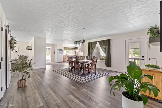 59301 Honeybee Rd, Senecaville, OH 43780 - dining area featuring a textured ceiling and wood finished floors