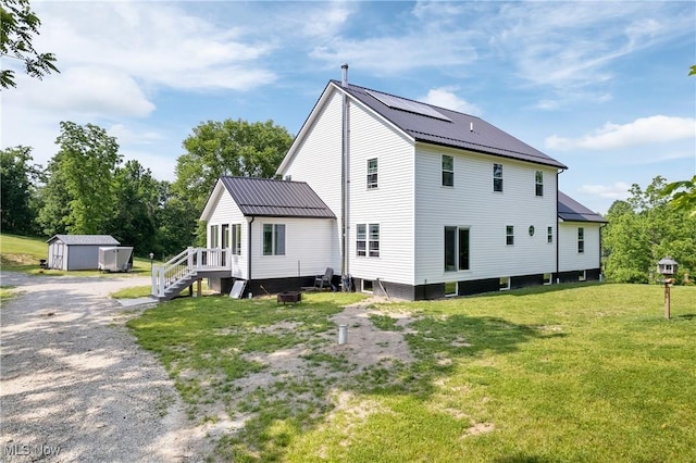 59301 Honeybee Rd, Senecaville, OH 43780 - back of house with a shed, a yard, and a metal roof