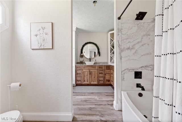 59301 Honeybee Rd, Senecaville, OH 43780 - bathroom with vanity, wood finished floors, shower / bath combination with curtain, and a textured ceiling