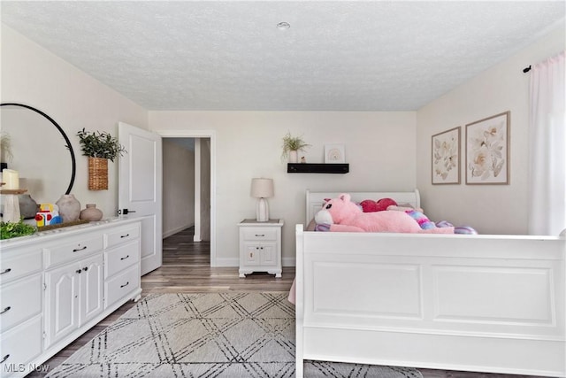 59301 Honeybee Rd, Senecaville, OH 43780 - bedroom with light wood-type flooring and a textured ceiling