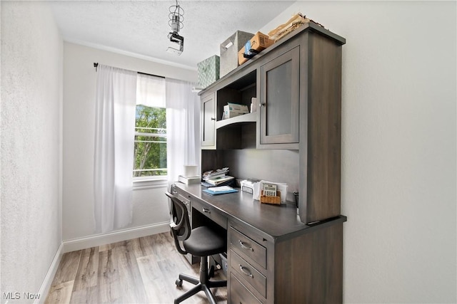 59301 Honeybee Rd, Senecaville, OH 43780 - home office with light wood-style floors, a textured ceiling, and built in desk
