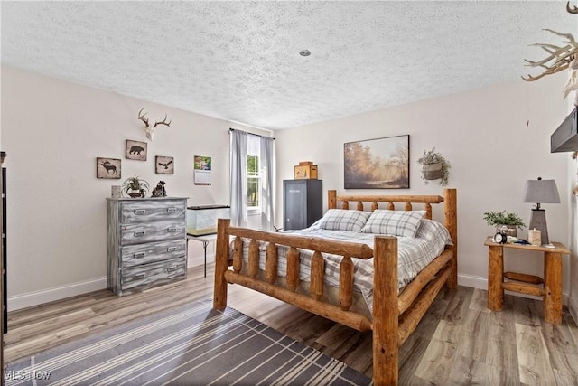 59301 Honeybee Rd, Senecaville, OH 43780 - bedroom with a textured ceiling and wood finished floors