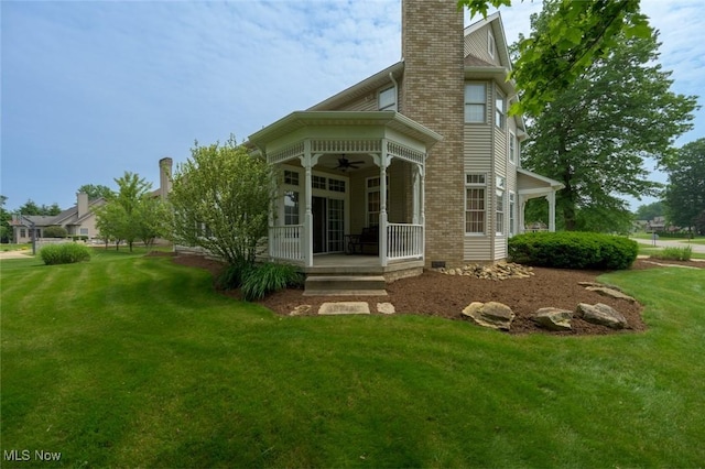 1015 Cambridge Ct NE, Warren, OH 44484 - rear view of property with ceiling fan, a yard, a chimney, and a porch