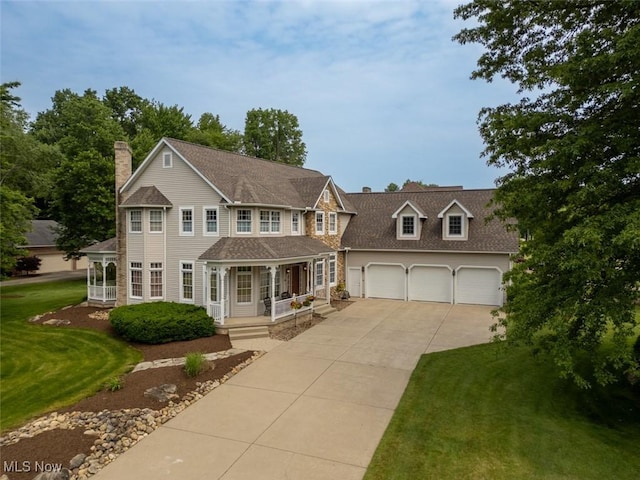 1015 Cambridge Ct NE, Warren, OH 44484 - colonial house featuring driveway, covered porch, a chimney, a front yard, and a garage