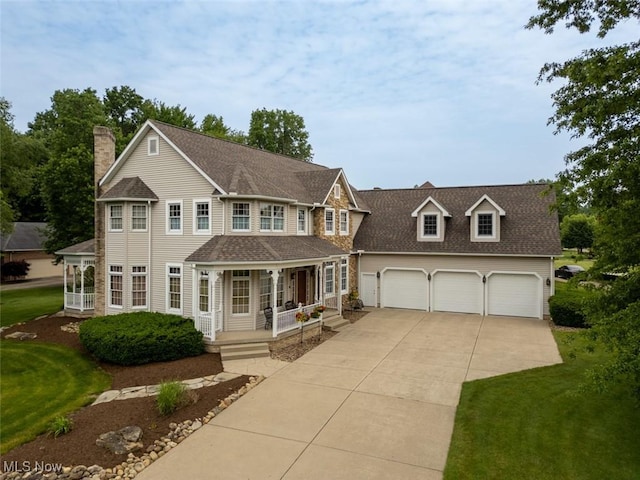 1015 Cambridge Ct NE, Warren, OH 44484 - colonial house with a porch, driveway, an attached garage, and a front lawn
