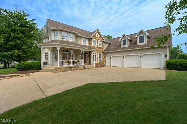 1015 Cambridge Ct NE, Warren, OH 44484 - view of front of property featuring covered porch, driveway, an attached garage, and a front yard