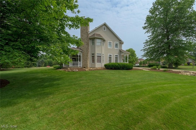 1015 Cambridge Ct NE, Warren, OH 44484 - view of front facade with a front yard and a chimney