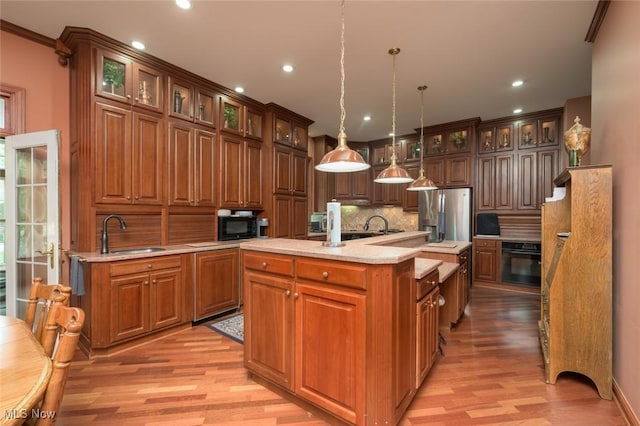 1015 Cambridge Ct NE, Warren, OH 44484 - kitchen featuring black appliances, light wood-type flooring, light countertops, decorative backsplash, and recessed lighting