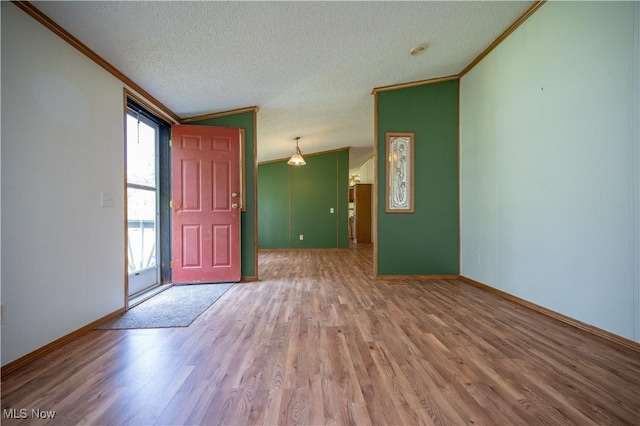 2500 Mcclintocksburg Rd, Deerfield, OH 44411 - foyer with ornamental molding, wood finished floors, and a textured ceiling