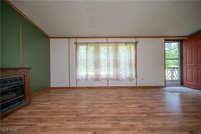 2500 Mcclintocksburg Rd, Deerfield, OH 44411 - unfurnished living room featuring crown molding, wood finished floors, and a textured ceiling