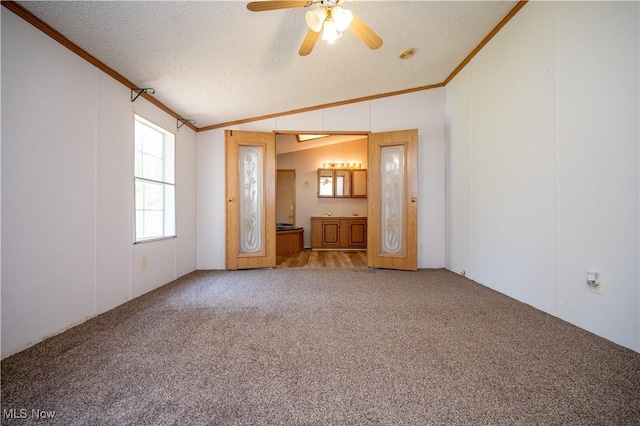 2500 Mcclintocksburg Rd, Deerfield, OH 44411 - carpeted empty room with crown molding, vaulted ceiling, ceiling fan, a textured ceiling, and a smoke detector