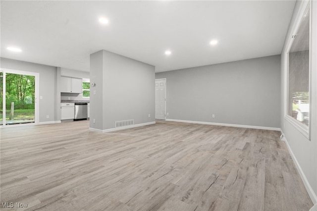 4232 Wilson Rd, Ravenna, OH 44266 - unfurnished living room with light wood-style floors and recessed lighting