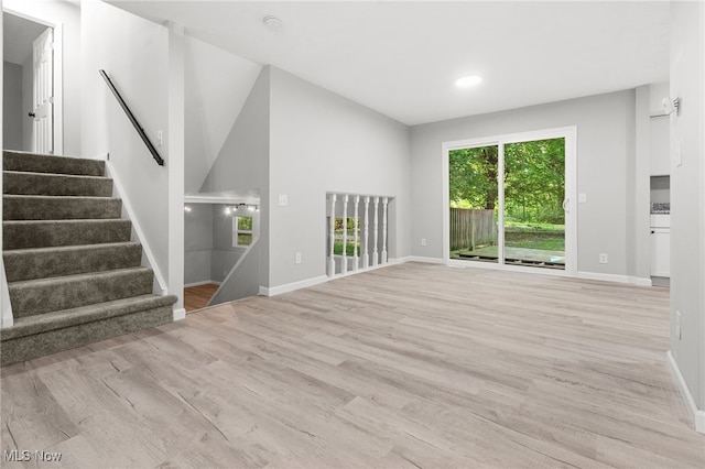 4232 Wilson Rd, Ravenna, OH 44266 - unfurnished living room with wood finished floors, stairs, and recessed lighting