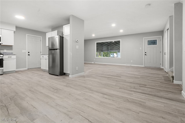 4232 Wilson Rd, Ravenna, OH 44266 - kitchen featuring appliances with stainless steel finishes, recessed lighting, white cabinetry, open floor plan, and light wood-style flooring