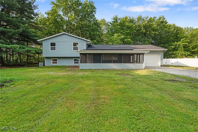 4232 Wilson Rd, Ravenna, OH 44266 - back of house with a sunroom, gravel driveway, and a garage