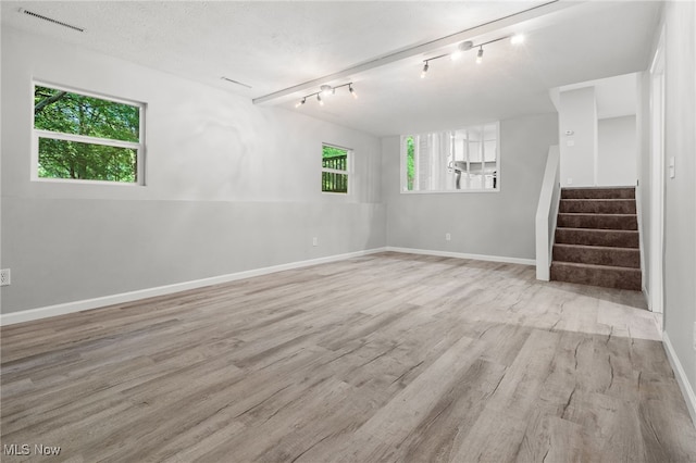 4232 Wilson Rd, Ravenna, OH 44266 - empty room with wood finished floors, stairs, and track lighting