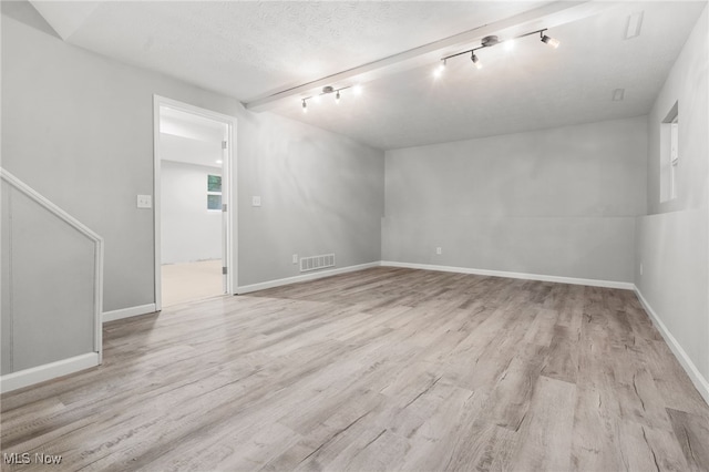 4232 Wilson Rd, Ravenna, OH 44266 - spare room featuring rail lighting and wood finished floors