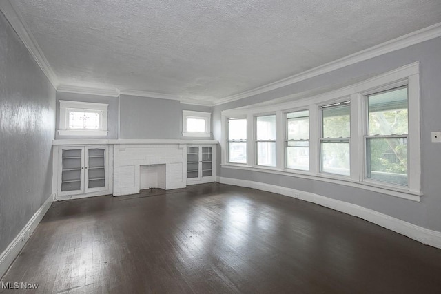 11515 Hopkins Ave, Cleveland, OH 44108 - unfurnished living room with dark wood-style flooring, a textured ceiling, plenty of natural light, a brick fireplace, and crown molding