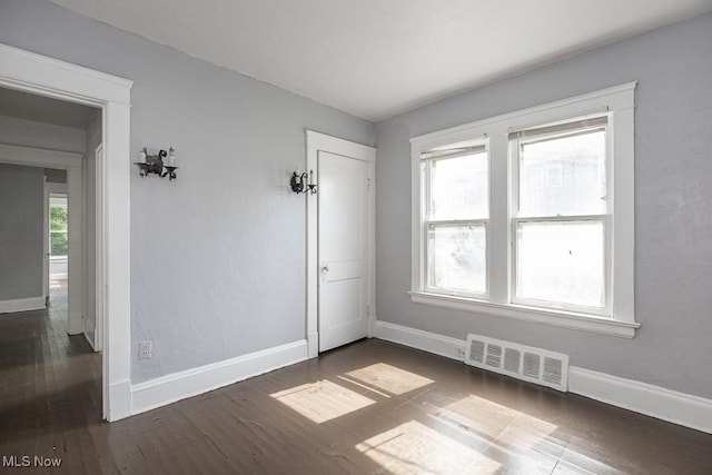 11515 Hopkins Ave, Cleveland, OH 44108 - spare room featuring baseboards and dark wood-style flooring