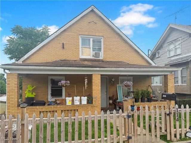 114 S 12th St, Weirton, WV 26062 - view of front of house featuring covered porch, brick siding, and a fenced front yard