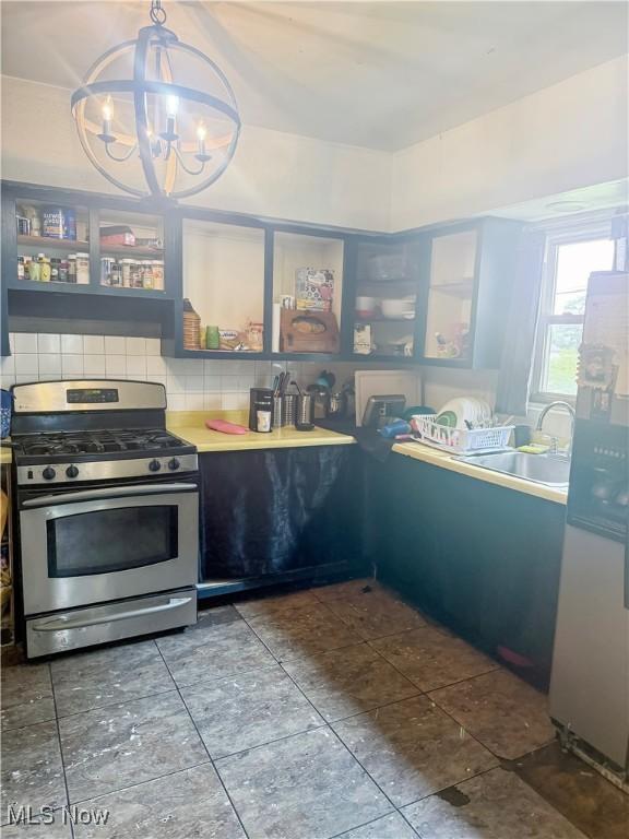 114 S 12th St, Weirton, WV 26062 - kitchen with stainless steel range with gas stovetop, backsplash, a chandelier, fridge with ice dispenser, and open shelves