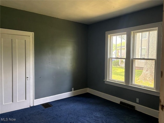 105 S Maple Hts, New Lexington, OH 43764 - spare room featuring dark colored carpet and baseboards