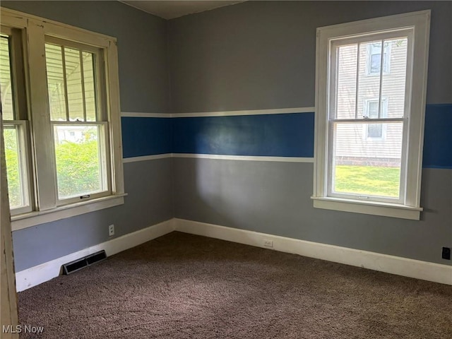 105 S Maple Hts, New Lexington, OH 43764 - spare room featuring dark colored carpet and healthy amount of natural light