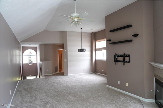 194 Vista Cir, North Olmsted, OH 44070 - unfurnished living room featuring ceiling fan, healthy amount of natural light, light colored carpet, vaulted ceiling, and a chandelier
