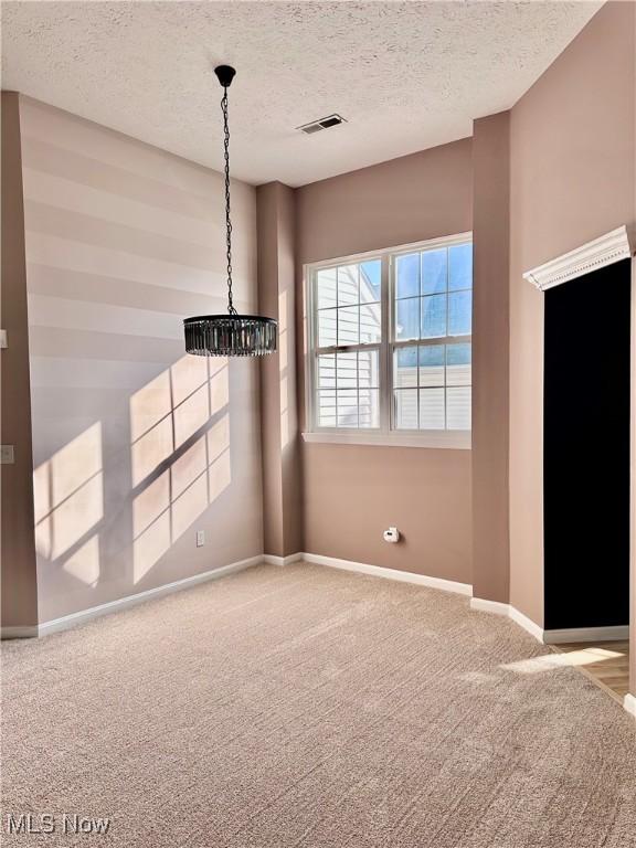 194 Vista Cir, North Olmsted, OH 44070 - carpeted empty room with a chandelier and a textured ceiling
