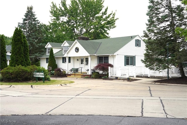 194 Vista Cir, North Olmsted, OH 44070 - view of front facade featuring covered porch and a chimney