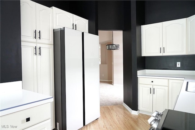 194 Vista Cir, North Olmsted, OH 44070 - kitchen with freestanding refrigerator, light countertops, and white cabinetry
