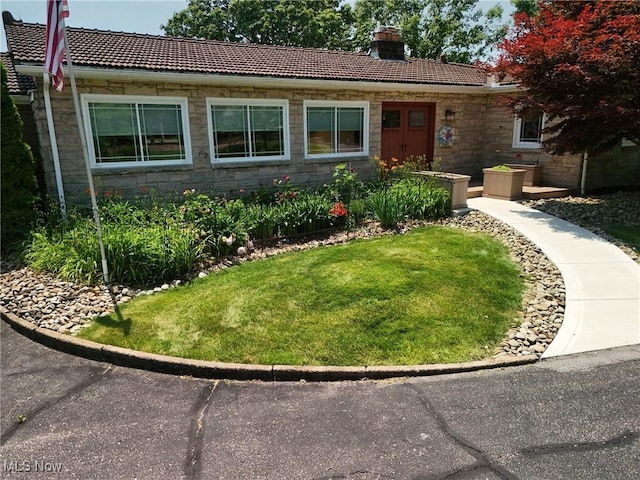 3901 Beaumont Dr, Weirton, WV 26062 - view of front of house with a tile roof, stone siding, a chimney, and a front lawn