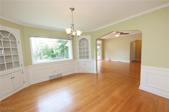 3901 Beaumont Dr, Weirton, WV 26062 - unfurnished dining area featuring arched walkways, a chandelier, light wood finished floors, crown molding, and a ceiling fan