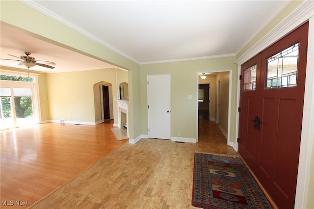 3901 Beaumont Dr, Weirton, WV 26062 - entrance foyer featuring arched walkways, light wood-style floors, a ceiling fan, and ornamental molding