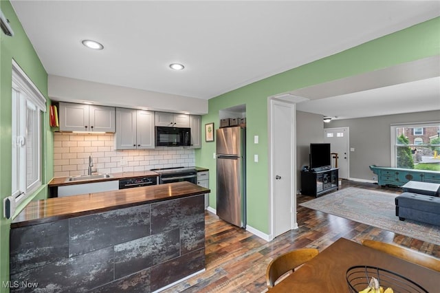 2400 Arlington Dr, Lyndhurst, OH 44124 - kitchen with black appliances, wooden counters, backsplash, dark wood-style flooring, and gray cabinetry