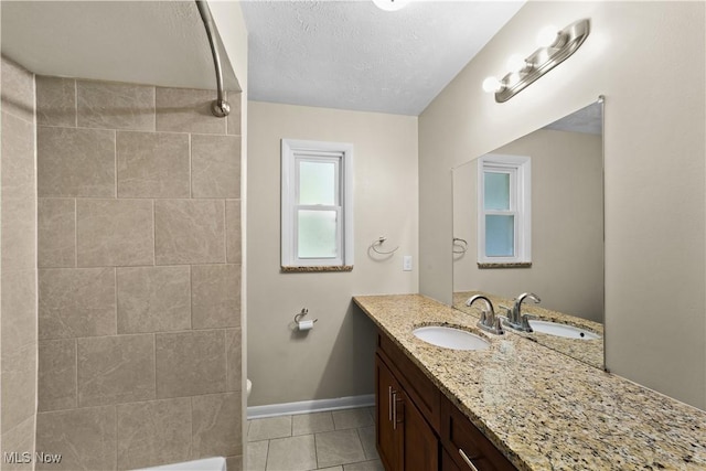 792 Miner Rd, Highland Heights, OH 44143 - full bath featuring vanity, tile patterned floors, a textured ceiling, and bathing tub / shower combination