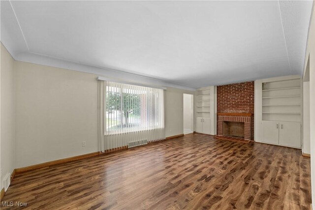 792 Miner Rd, Highland Heights, OH 44143 - unfurnished living room featuring wood finished floors, built in shelves, and a fireplace
